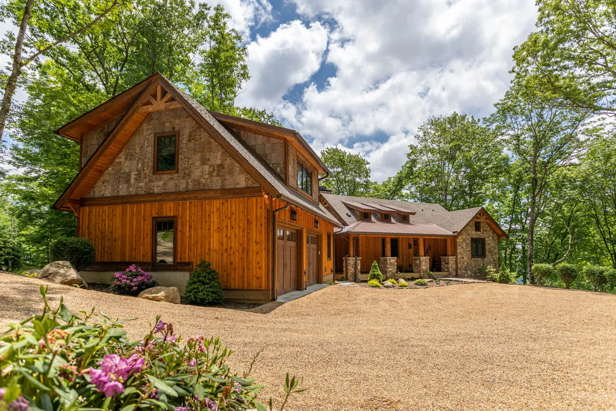 This exterior shot showcases the cabin’s wooden exterior, stone accents, and landscaped garden, with a driveway leading up to the home. The setting suggests a welcoming basecamp for families, with ample space for outdoor activities and the surrounding natural beauty of Eagles Nest.